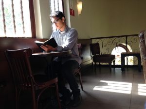student reading in cafe